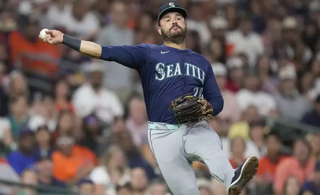 Seattle Mariners third baseman Eugenio Suárez (28) throws out Houston Astros' Jake Meyers on a ground ball during the third inning of a baseball game Friday, Sept. 19, 2025, in Houston. (AP Photo/Kevin M. Cox)