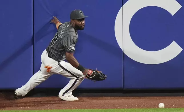 New York Mets' Cedric Mullins runs after a ball hit by Washington Nationals' Daylen Lile for a two-run inside-the-park home run during the 11th inning of a baseball game Saturday, Sept. 20, 2025, in New York. (AP Photo/Frank Franklin II)
