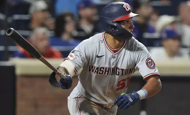 Washington Nationals' Daylen Lile (51) watches a ball he hit for a two-run inside-the-park home run during the 11th inning of a baseball game against the New York Mets Saturday, Sept. 20, 2025, in New York. (AP Photo/Frank Franklin II)