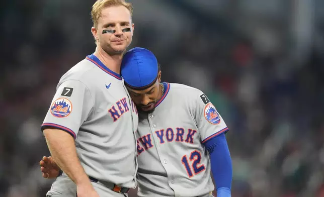 New York Mets' Pete Alonso, left, stands with Francisco Lindor after flying out with the bases loaded during the fifth inning of a baseball game against the Miami Marlins, Sunday, Sept. 28, 2025, in Miami. (AP Photo/Lynne Sladky)