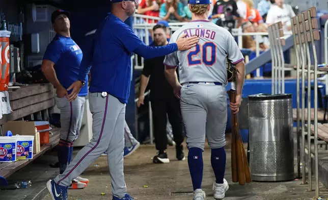 New York Mets' Pete Alonso (20) walks through the dugout after the Mets lost to the Miami Marlins in a baseball game, Sunday, Sept. 28, 2025, in Miami. (AP Photo/Lynne Sladky)