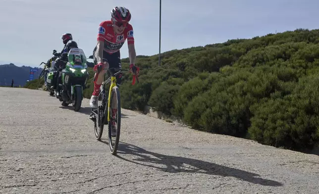 Danish cyclist Jonas Vingegaard completes the final meters before winning the 20th stage and his first overall victory in the Spanish cycling race La Vuelta, from Robledo de Chavela to Bola del Mundo, in Puerto de Navacerrada, Spain, on Saturday, September 13, 2025. (AP Photo/Manu Fernández)