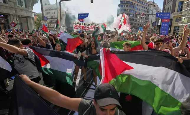 Protesters block the road in an attempt to disrupt the twenty-first stage of the Spanish cycling race La Vuelta, from Alalpardo to Madrid, Spain, Sunday, Sept. 14, 2025. (AP Photo/Manu Fernández)