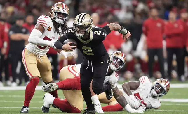 New Orleans Saints quarterback Spencer Rattler (2) runs against the San Francisco 49ers during the first half of an NFL football game in New Orleans, Sunday, Sept. 14, 2025. (AP Photo/Gerald Herbert)