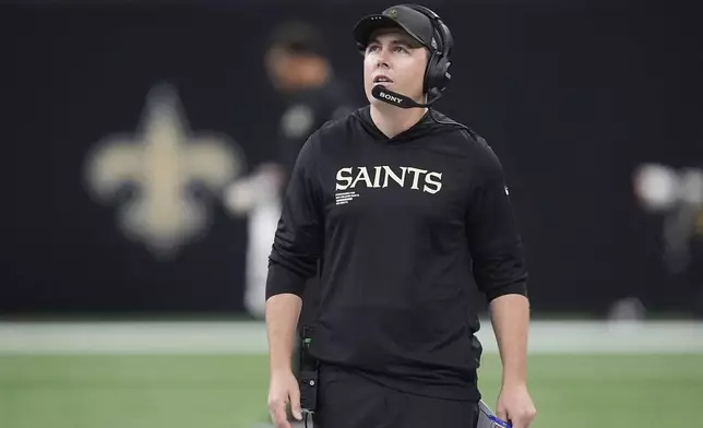New Orleans Saints head coach Kellen Moore watches from the sideline during the first half of an NFL football game against the San Francisco 49ers in New Orleans, Sunday, Sept. 14, 2025. (AP Photo/Gerald Herbert)