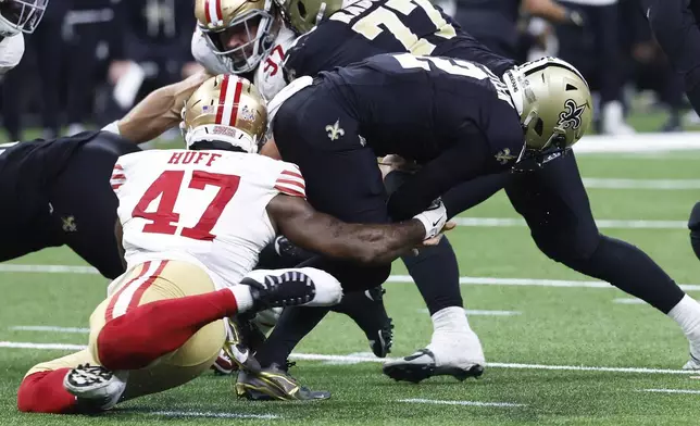 San Francisco 49ers defensive end Bryce Huff (47) sacks New Orleans Saints quarterback Spencer Rattler (2) and forces a fumble, which was recovered by the Saints but the ball changed possesion on downs, during the second half of an NFL football game in New Orleans, Sunday, Sept. 14, 2025. (AP Photo/Butch Dill)