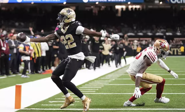 New Orleans Saints wide receiver Rashid Shaheed (22) scores past San Francisco 49ers safety Jason Pinnock during the second half of an NFL football game in New Orleans, Sunday, Sept. 14, 2025. (AP Photo/Gerald Herbert)