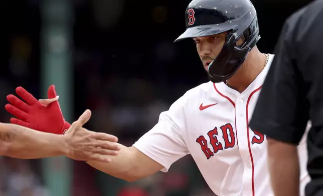 Boston Red Sox's Carlos Narváez os congratulated after hitting a two-RBI single during the fifth inning of a baseball game against the Cleveland Guardians, Monday, Sept. 1, 2025, in Boston. (AP Photo/Mark Stockwell)