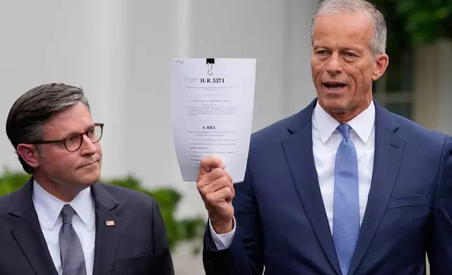 Senate Majority Leader John Thune, R-S.D., talks to reporters outside the West Wing of the White House, Monday, Sept. 29, 2025, in Washington, as House Speaker Mike Johnson of La., listens. (AP Photo/Alex Brandon)