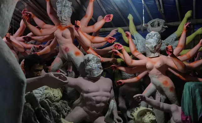 Idols of Hindu gods and goddesses are prepared ahead of the Durga Puja festival in New Delhi, India, Friday, Sept. 19, 2025. (AP Photo/Manish Swarup)
