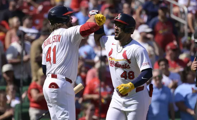 St. Louis Cardinals' Ivan Herrera (48) reacts with Alec Burleson (41) after hitting a two-run home run against the Milwaukee Brewers during the third inning of a baseball game Sunday, Sept. 21, 2025, in St. Louis. (AP Photo/Jeff Le)