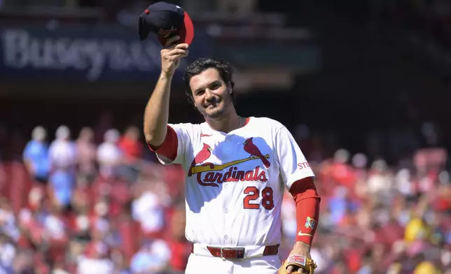 St. Louis Cardinals third baseman Nolan Arenado (28) salutes the crowd as he leaves the field during the first inning of a baseball game against the Milwaukee Brewers Sunday, Sept. 21, 2025, in St. Louis. (AP Photo/Jeff Le)