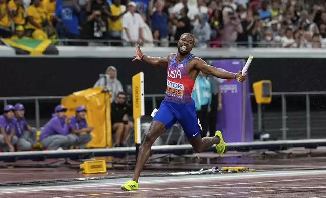United States' Noah Lyles crosses the finish line to win the men's 4 X 100 meters relay at the World Athletics Championships in Tokyo, Sunday, Sept. 21, 2025. (AP Photo/Matthias Schrader)