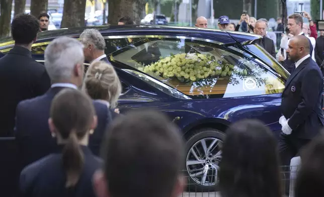 A hearse carries the coffin of the late fashion designer Giorgio Armani, at the Armani/Teatro in Milan, northern Italy, Saturday, Sept. 6, 2025. (AP Photo/Antonio Calanni)