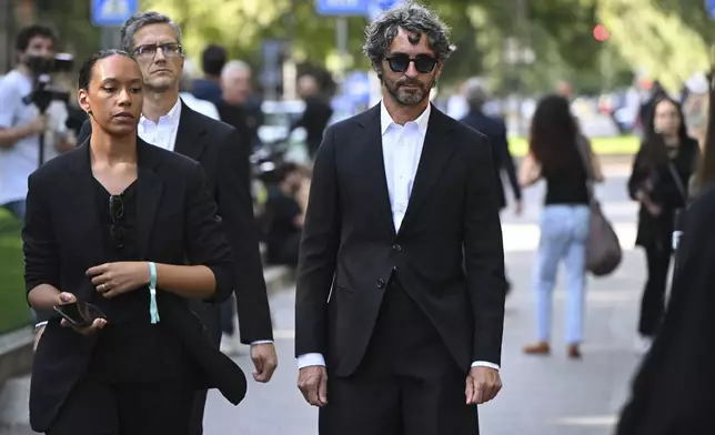 Editor in chief of Vanity Fair Italia, Simone Marchetti, right, arrives at the Armani/Teatro in Milan, northern Italy, to pay his respects to designer Giorgio Armani, who died Thursday at age 91, Saturday, Sept. 6, 2025. (AP Photo/Nicola Marfisi)