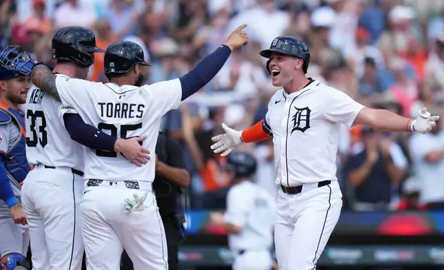 CORRECTS INNING TO SEVENTH, NOT EIGHTH - Detroit Tigers designated hitter Kerry Carpenter, right, celebrates with Colt Keith, left, and Gleyber Torres, after hitting a three-run home run during the seventh inning of a baseball game against the New York Mets, Wednesday, Sept. 3, 2025, in Detroit. (AP Photo/Ryan Sun)