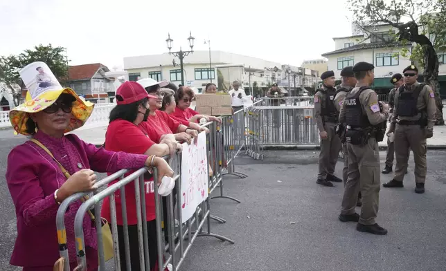Supporters of Thailand's former Prime Minister Thaksin Shinawatra gather outside the Supreme Court in Bangkok, Thailand, Tuesday, Sept. 9, 2025, (AP Photo/Sakchai Lalit)