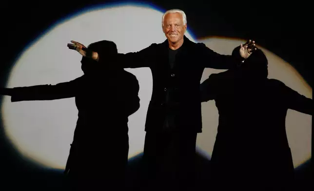 FILE - Giorgio Armani receives his share of applause after presenting his Emporio Fall-Winter 2007-2008 men's fashion collection, during the Milan Men's Fashion Week, in Milan, Italy, Monday, Jan. 15, 2007. (AP Photo/Luca Bruno, File)