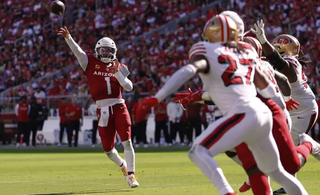 Arizona Cardinals quarterback Kyler Murray, left, throws a touchdown pass during the second half of an NFL football game against the San Francisco 49ers, Sunday, Sept. 21, 2025, in Santa Clara, Calif. (AP Photo/Sergio Estrada)