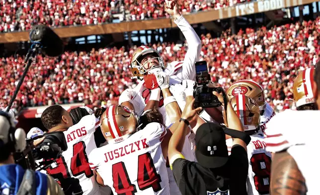 San Francisco 49ers kicker Eddy Pineiro, top, celebrates after his winning field goal against the Arizona Cardinals in an NFL football game in Santa Clara, Calif., Sunday, Sept. 21, 2025. (Scott Strazzante/San Francisco Chronicle via AP)