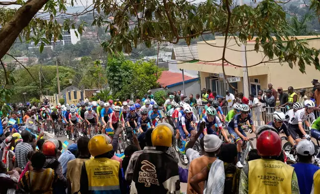 The pack of riders makes its way during the men's Under 23 road race, at the road cycling World Championships in Kigali, Rwanda, Friday, Sept. 26, 2025. (AP Photo/Jerome Delay)