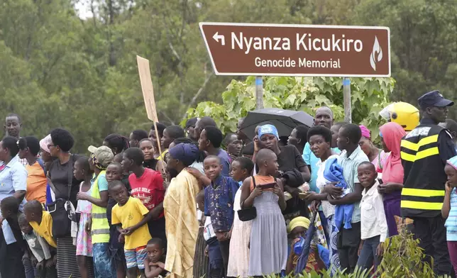 Spectators stand by the track to watch the women's Under 23 individual time trial event, at the road cycling World Championships in Kigali, Rwanda, Monday, Sept. 22, 2025. (AP Photo/Jerome Delay)