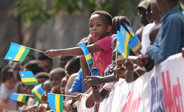 A boy blows a whistle as he cheers during the men's Under 23 road race, at the road cycling World Championships in Kigali, Rwanda, Friday, Sept. 26, 2025. (AP Photo/Jerome Delay)