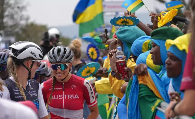 Cyclists, left, gather ahead of the women's Under 23 race, at the road cycling World Championships in Kigali, Rwanda, Thursday, Sept. 25, 2025. (AP Photo/Jerome Delay)