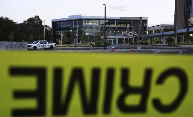 Crime scene tape surrounds Utah Valley University after Turning Point USA CEO and co-founder Charlie Kirk was shot and killed , Saturday, Sept. 13, 2025, in Orem, Utah. (AP Photo/Lindsey Wasson)