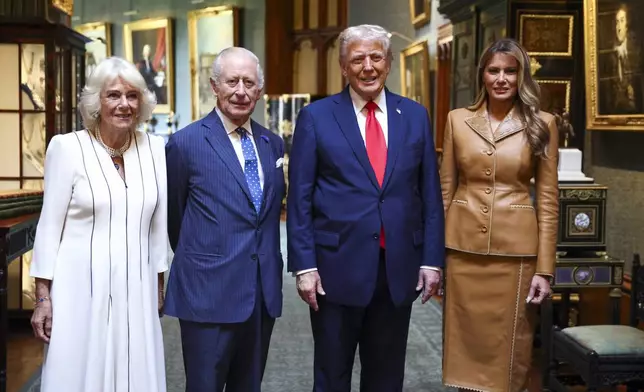 President Donald Trump and first lady Melania Trump, right, stand next to Britain's King Charles III and Queen Camilla as they bid their farewells during Donald Trump's departure from Windsor Castle, in Windsor, England, Thursday, Sept. 18, 2025. (Kevin Lamarque/Pool Photo via AP)
