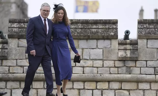 British Prime Minister Sir Keir Starmer and wife, Lady Victoria Starmer, arrive for the Beating Retreat military ceremony at Windsor Castle, England, on Wednesday Sept. 17, 2025, day one of the president's second state visit to the UK. (Andrew Matthews/PA via AP, Pool)