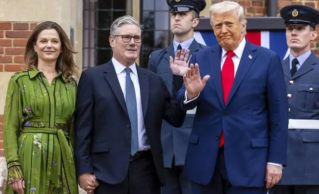 President Donald Trump, foreground right is greeted by Britain's Prime Minister Keir Starmer and his wife Victoria, as he visits the prime minister's country residence Chequers, near Aylesbury, England, Thursday, Sept. 18, 2025. (Ian Vogler/Pool Photo via AP)