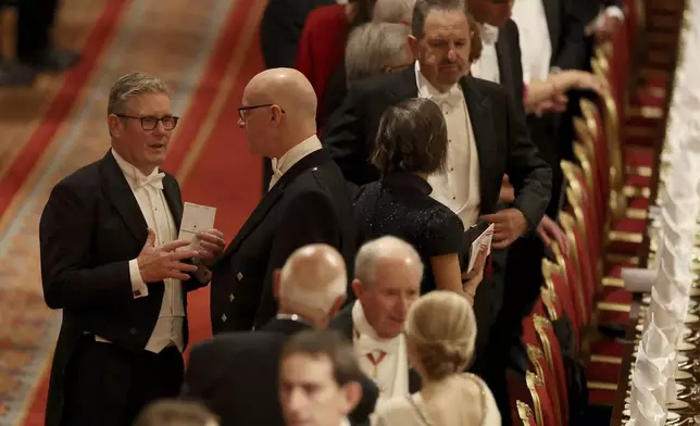 Britain's Prime Minister Keir Starmer, left, arrives for a State Banquet at Windsor Castle, in Windsor, England, Sept. 17, 2025. (Phil Noble/Pool Photo via AP)