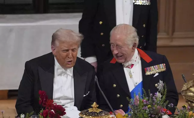 U.S. President Donald Trump, left, and Britain's King Charles speak during the State Banquet in Windsor Castle, England, on day one of U.S. President Donald Trump and First Lady Melania Trump's second state visit to the UK, Wednesday Sept. 17, 2025. (Yui Mok/PA via AP, Pool Photo via AP)
