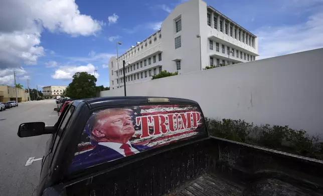 A pickup truck decorated in support of President Donald Trump sits parked outside the Alto Lee Adams Sr. U.S. Courthouse, after the start of jury selection in the trial of Ryan Routh, charged with trying to assassinate Trump while he played golf last year in South Florida, Monday, Sept. 8, 2025, in Fort Pierce, Fla. (AP Photo/Rebecca Blackwell)