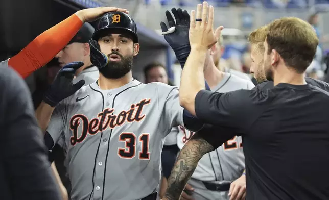 Detroit Tigers' Riley Greene (31) is congratulated in the dugout after hitting a solo home run during the fourth inning of a baseball game against the Miami Marlins, Friday, Sept. 12, 2025, in Miami. (AP Photo/Lynne Sladky)