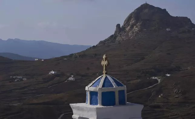 Family-owned chapels stand on the Aegean Sea island of Tinos, Greece, Sunday, Sept. 7, 2025. (AP Photo/Petros Giannakouris)