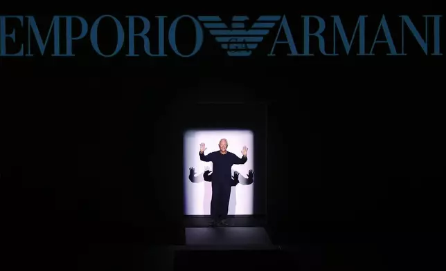FILE - Fashion designer Giorgio Armani acknowledges the applause after presenting his Emporio Armani men's Fall-Winter 2017-2018 collection, part of the Milan Fashion Week, unveiled in Milan, Italy, Saturday, Jan. 14, 2017. (AP Photo/Antonio Calanni, File)