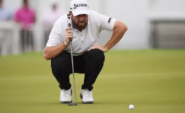 FILE - Shane Lowry, of Ireland, lines up a putt on the third green during the final round of the Tour Championship golf tournament, Sunday, Aug. 24, 2025, in Atlanta. (AP Photo/Mike Stewart, file)