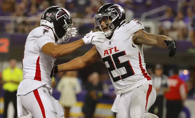 Atlanta Falcons running back Tyler Allgeier (25) celebrates a touchdown during the second half of an NFL football game against the Minnesota Vikings, Sunday, Sept. 14, 2025, in Minneapolis. (AP Photo/Bruce Kluckhohn)
