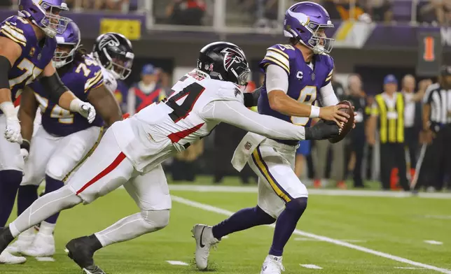 Atlanta Falcons defensive tackle Brandon Dorlus (54) sacks Minnesota Vikings quarterback J.J. McCarthy (9) during the first half of an NFL football game, Sunday, Sept. 14, 2025, in Minneapolis. (AP Photo/Bruce Kluckhohn)