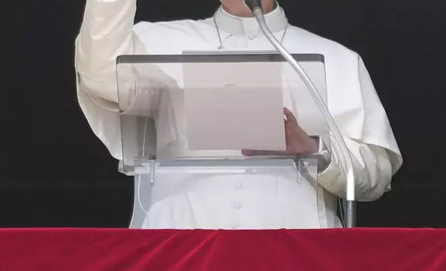 Pope Leo XIV appears at his studio's window to bless the faithful gathered in St. Peter's Square at the Vatican for the Angelus prayer, Sunday, Sept. 14, 2025. (AP Photo/Gregorio Borgia)