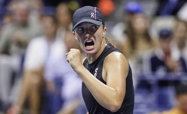 Iga Swiatek, of Poland, reacts after winning a game against Anna Kalinskaya, of Russia, during the third round of the U.S. Open tennis championships, Saturday, Aug. 30, 2025, in New York. (AP Photo/Adam Hunger)