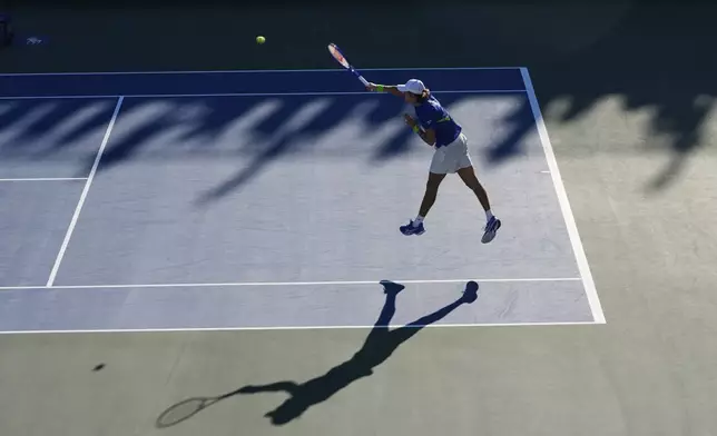 Alex de Minaur, of Australia, returns a shot against Daniel Altmaier, of Germany, during the third round of the U.S. Open tennis championships, Saturday, Aug. 30, 2025, in New York. (AP Photo/Pamela Smith)