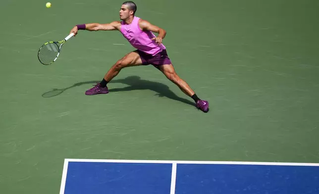 Carlos Alcaraz, of Spain, returns a shot to Luciano Darderi, of Italy, during the third round of the U.S. Open tennis championships, Friday, Aug. 29, 2025, in New York. (AP Photo/Yuki Iwamura)