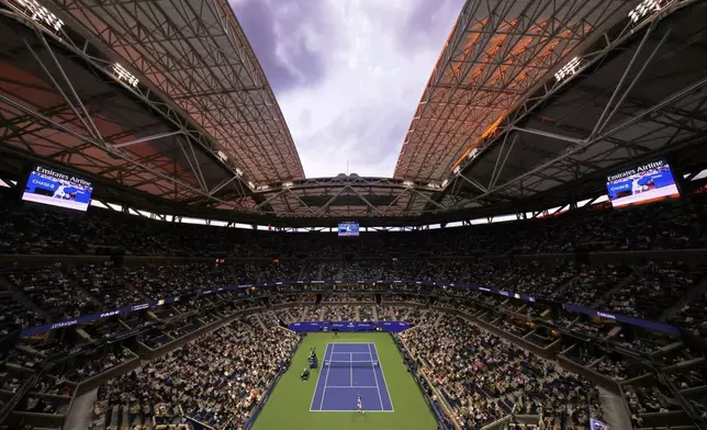 Fans watch the match between Novak Djokovic, of Serbia, and Cameron Norrie, of Great Britain, during the third round of the U.S . Open tennis championships, Friday, Aug. 29, 2025, in New York. (AP Photo/Adam Hunger)