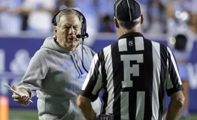 North Carolina head coach Bill Belichick, left, discusses a call with an official, right, during the second half of an NCAA college football game against TCU, Monday, Sept. 1, 2025, in Chapel Hill, N.C. (AP Photo/Chris Seward)