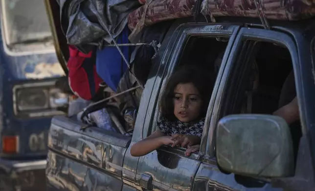 Displaced Palestinians flee northern Gaza along the coastal road toward the south, after Israel's military says its expanded operation in Gaza City has begun and warns residents to leave, Tuesday, Sept. 16, 2025. (AP Photo/Abdel Kareem Hana)