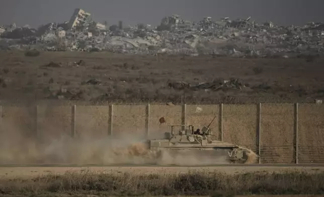 An Israeli armored vehicle moves along the Israeli-Gaza border as seen from southern Israel, Tuesday, Sept. 16, 2025. (AP Photo/Leo Correa)