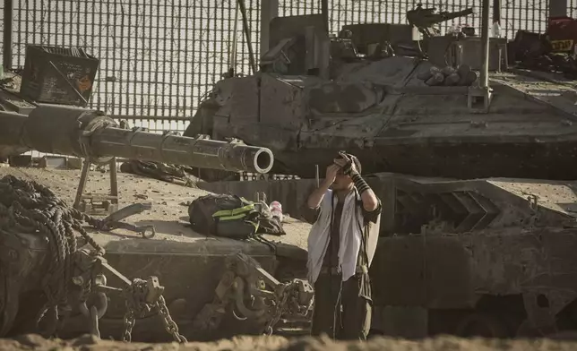 An Israeli soldier prays at a staging area on the border with Gaza Strip, as seen from southern Israel, Tuesday, Sept. 16, 2025. (AP Photo/Leo Correa)